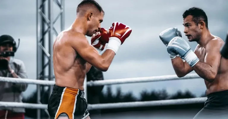 Two fighters guard in a ring during beginner Muay Thai training
