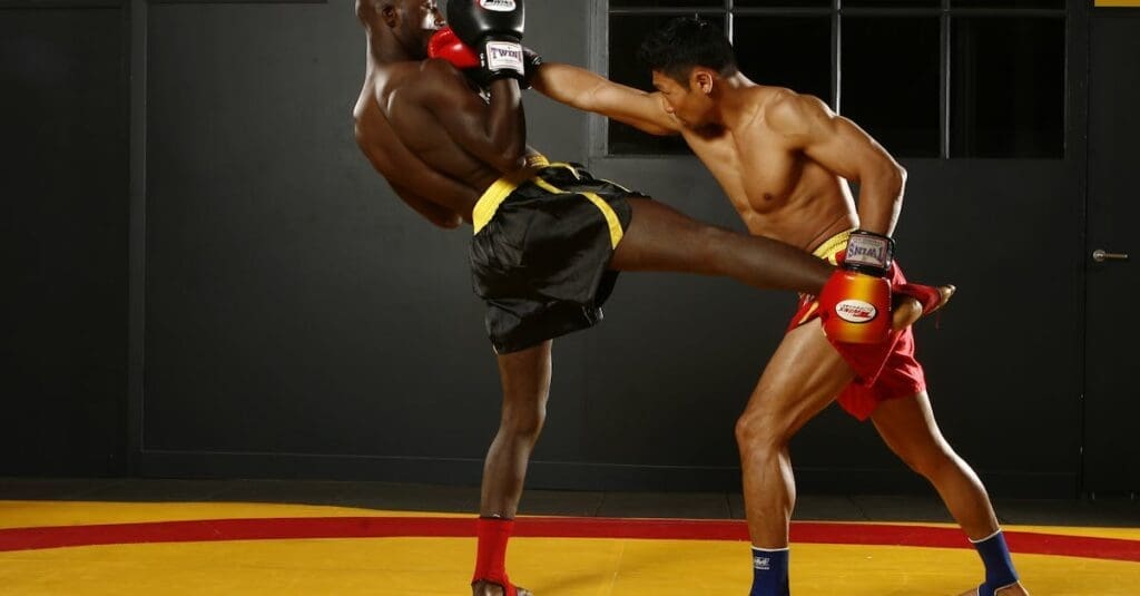 Fighter lands body kick during Muay Thai techniques practice