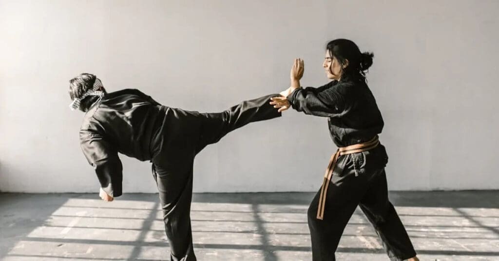 Partners drilling controlled kicks to show how martial arts training works